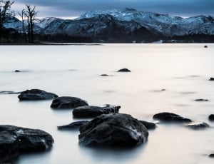 photography of stones and body of water thumbnail