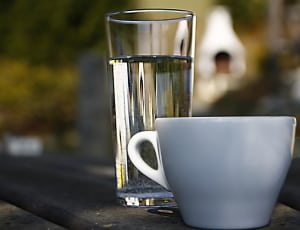white ceramic teacup and clear drinking glass thumbnail