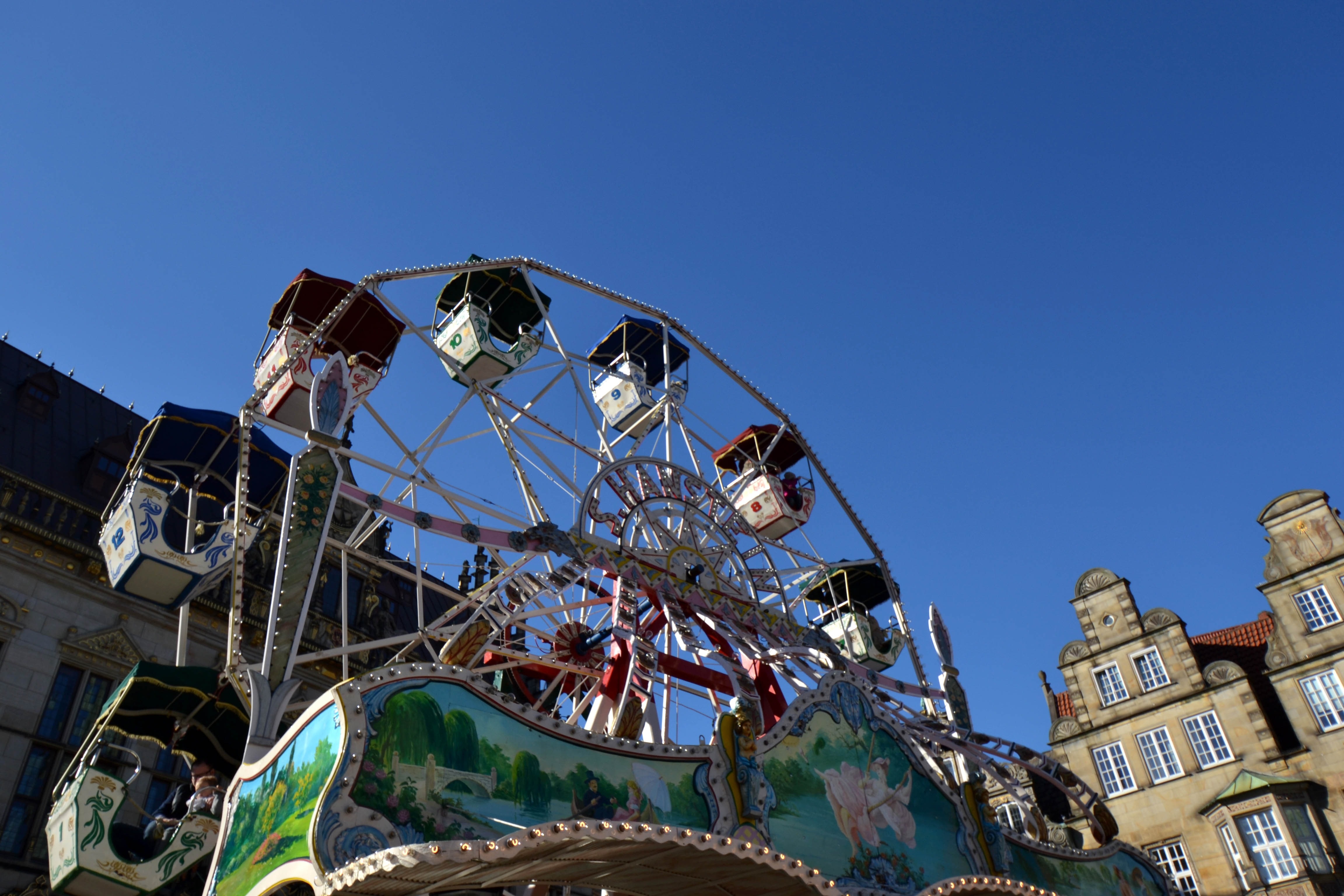low angle view of ferris wheel under blue skies