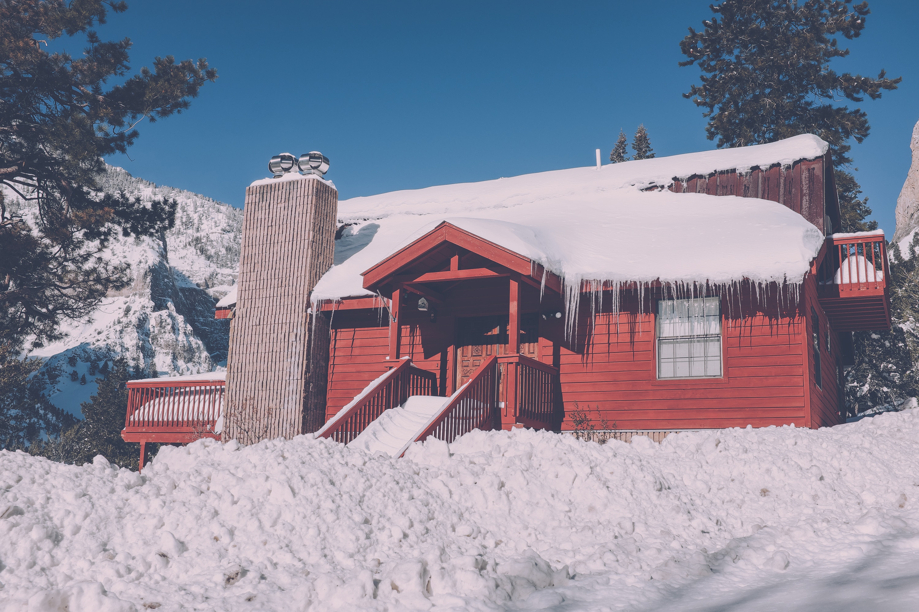 red painted wooden shed with snow