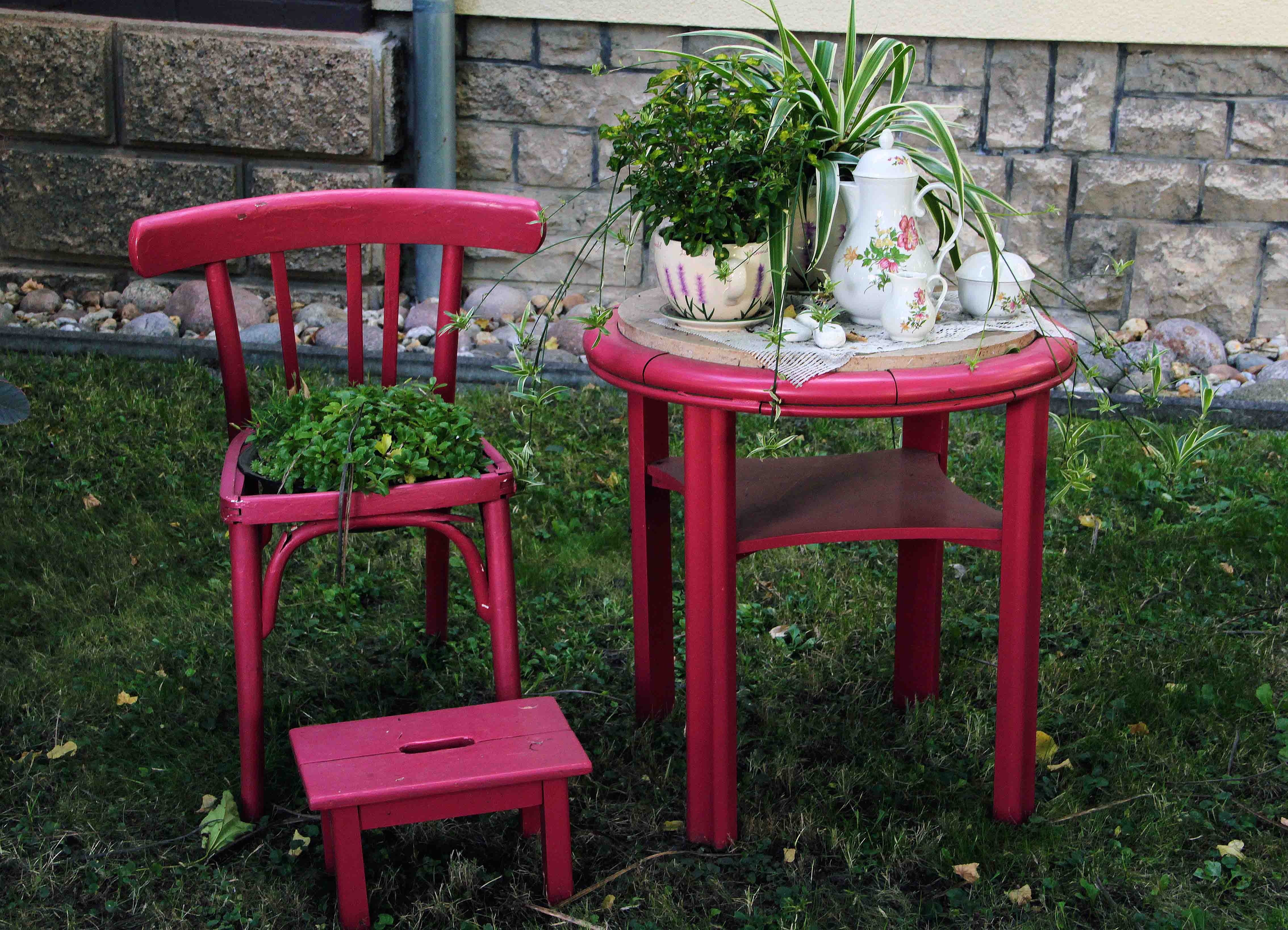 three purple table and chair set outside the yard
