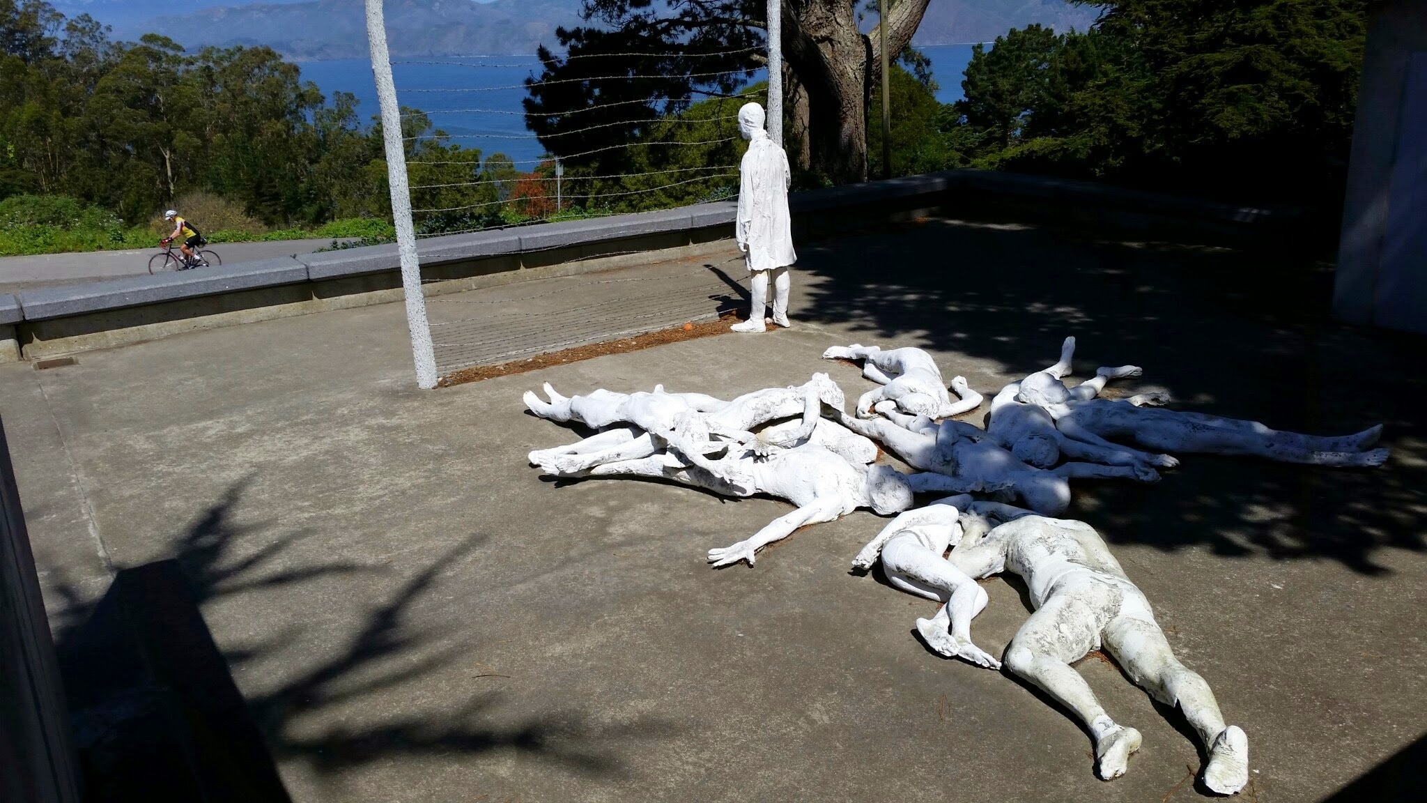 human's white statue lot near the road