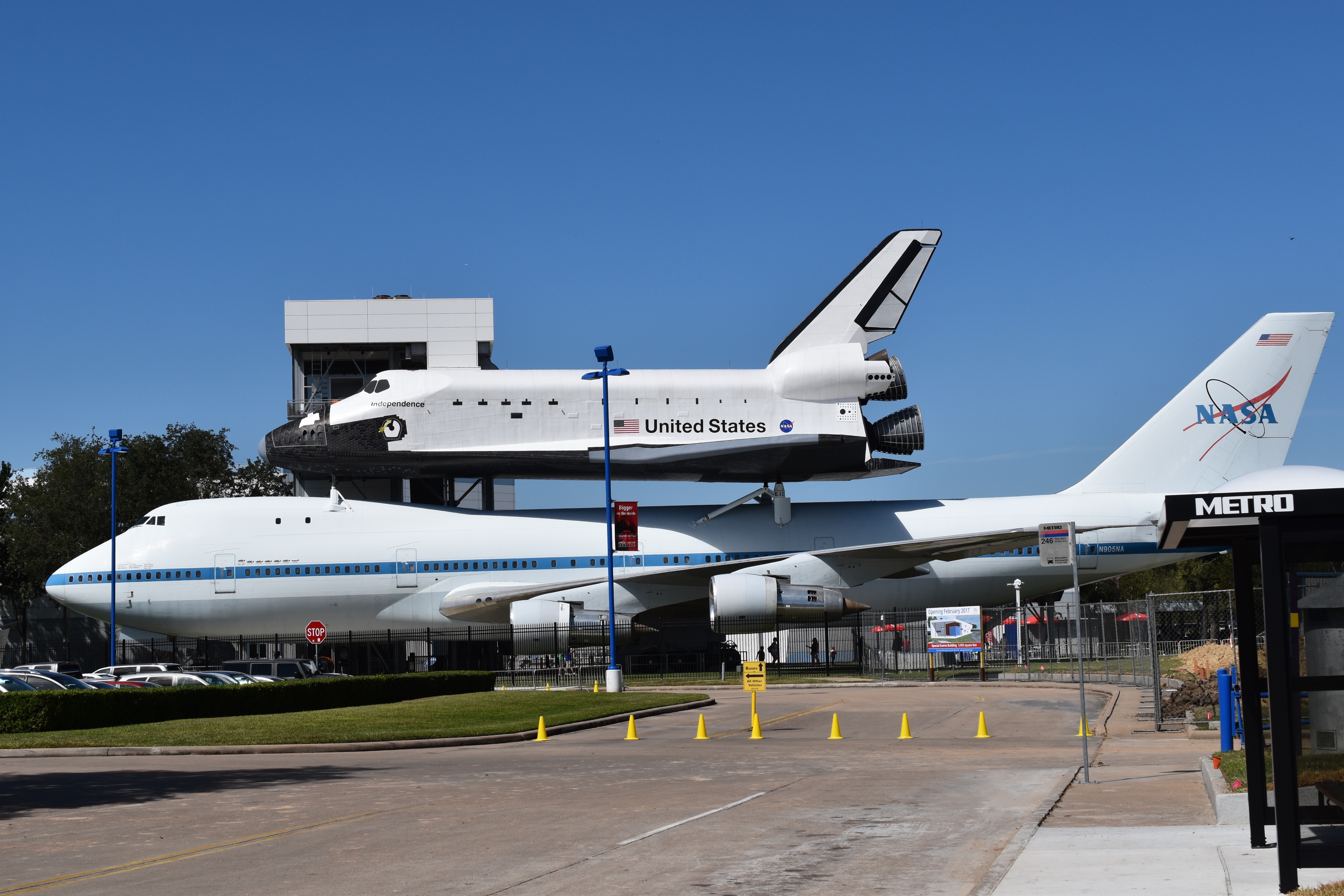 white nasa passenger plane with white and black united states space shuttle during day time