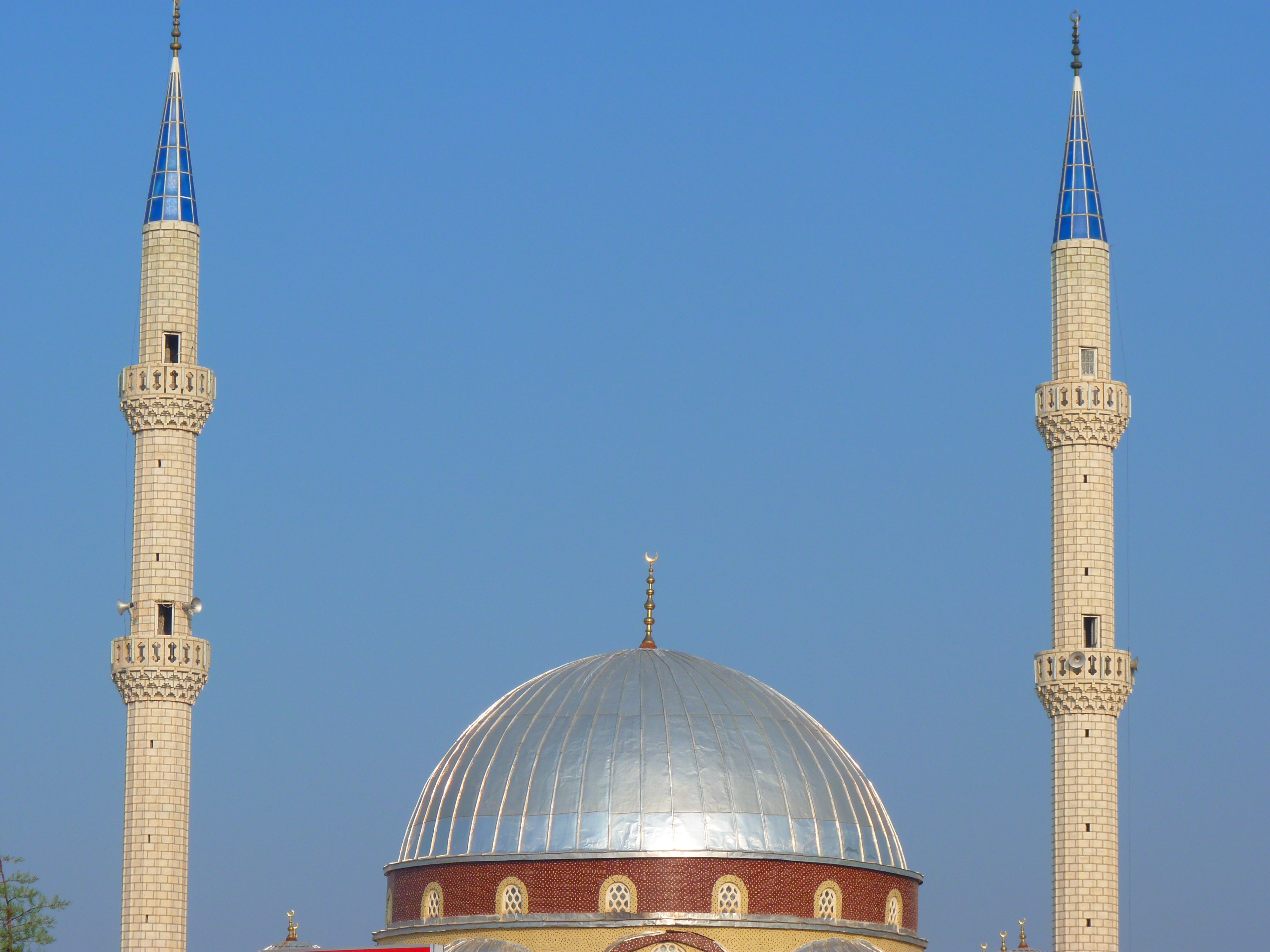 red and gray dome mosque with 2 towers