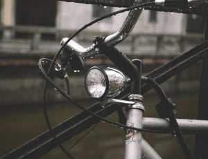 silver round light under bicycle handle bar thumbnail