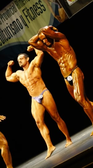 two men showing their muscles on strage thumbnail