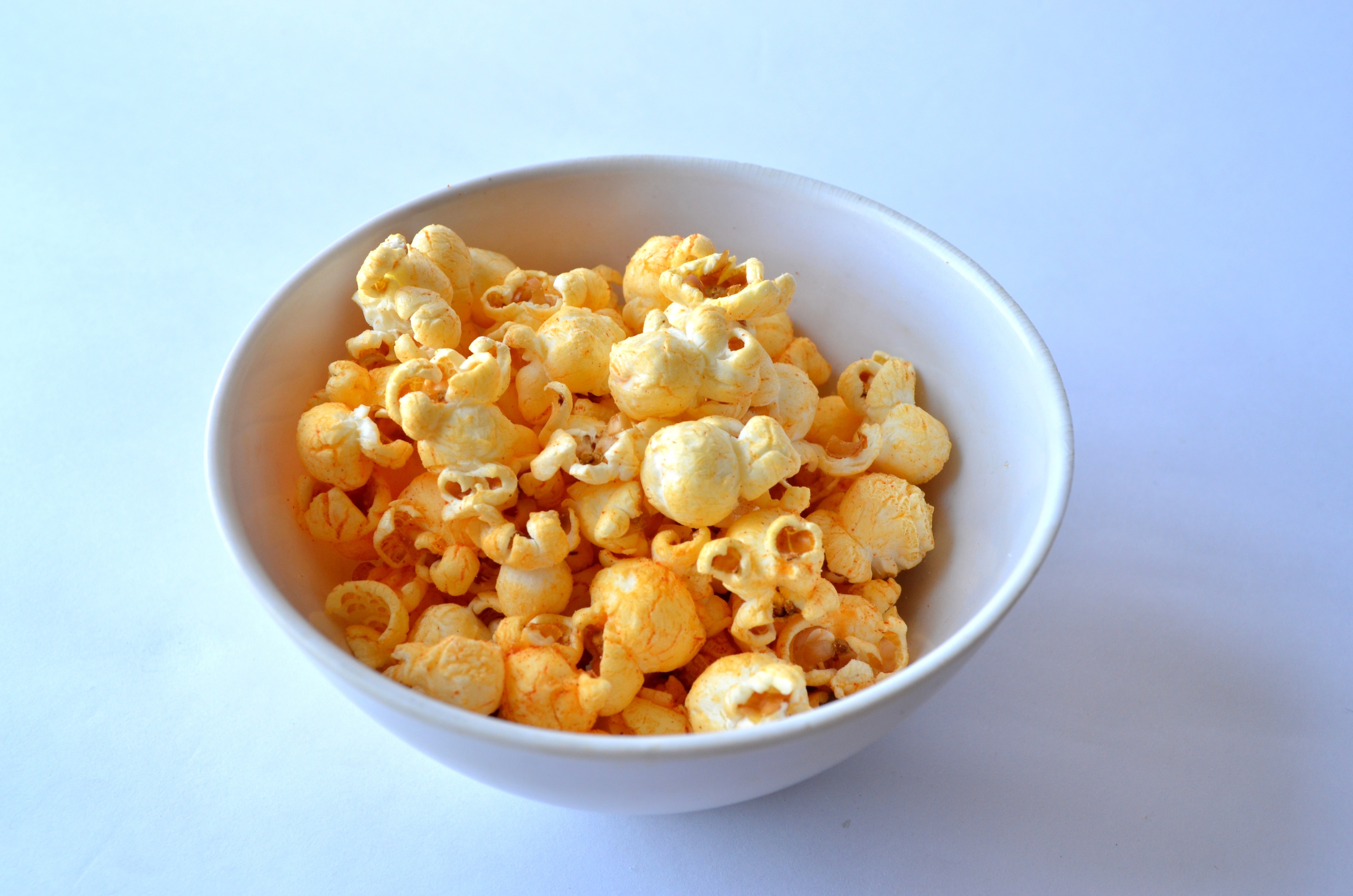 white ceramic bowl with cheese popcorn