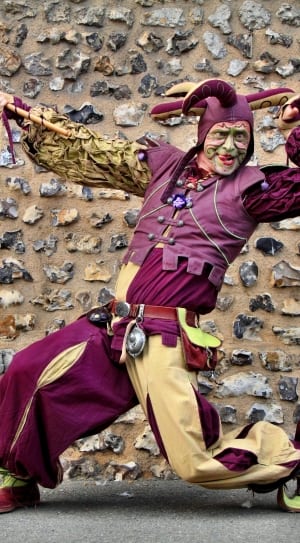 clown in purple and yellow costume thumbnail