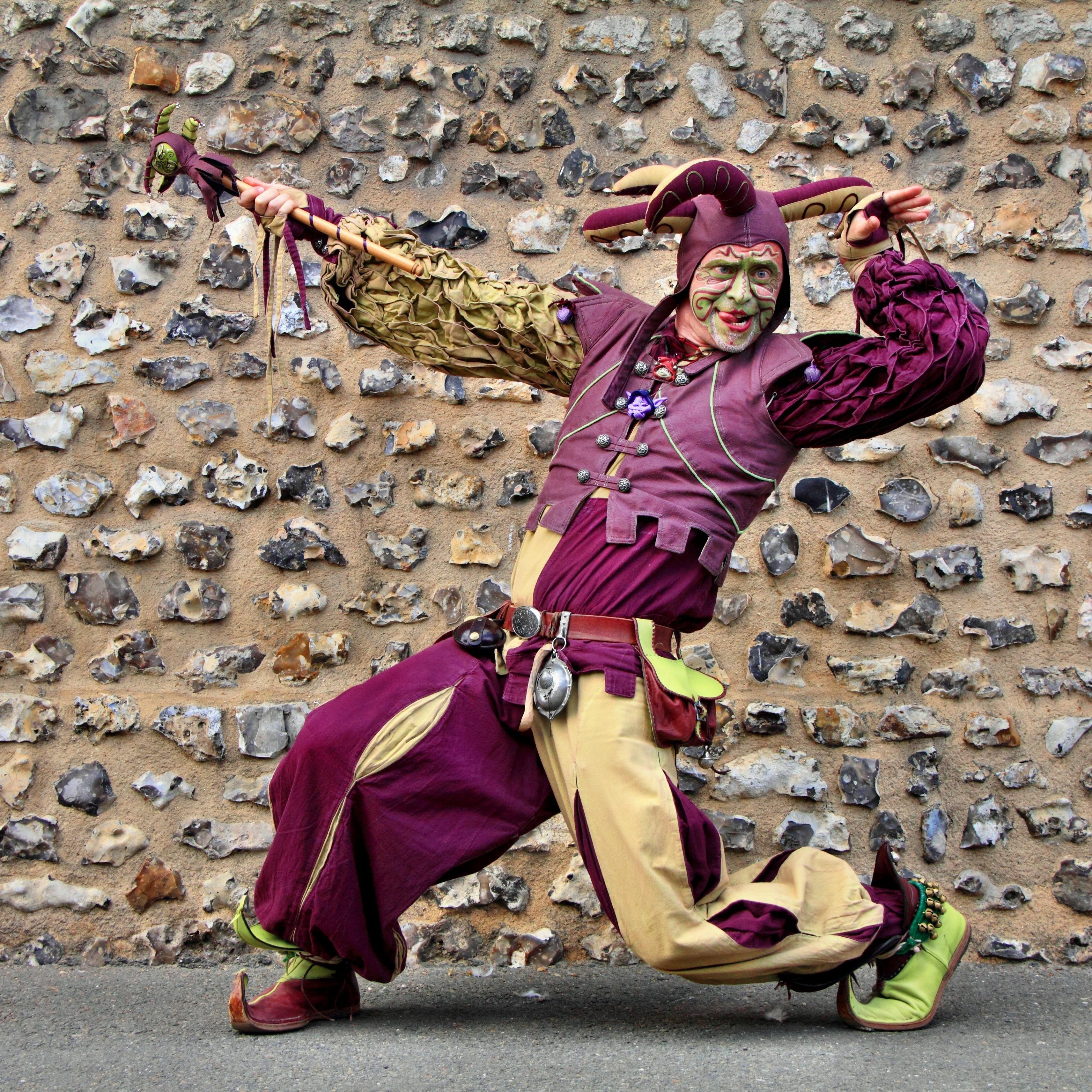 clown in purple and yellow costume