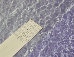 white diving board above water closeup photo thumbnail