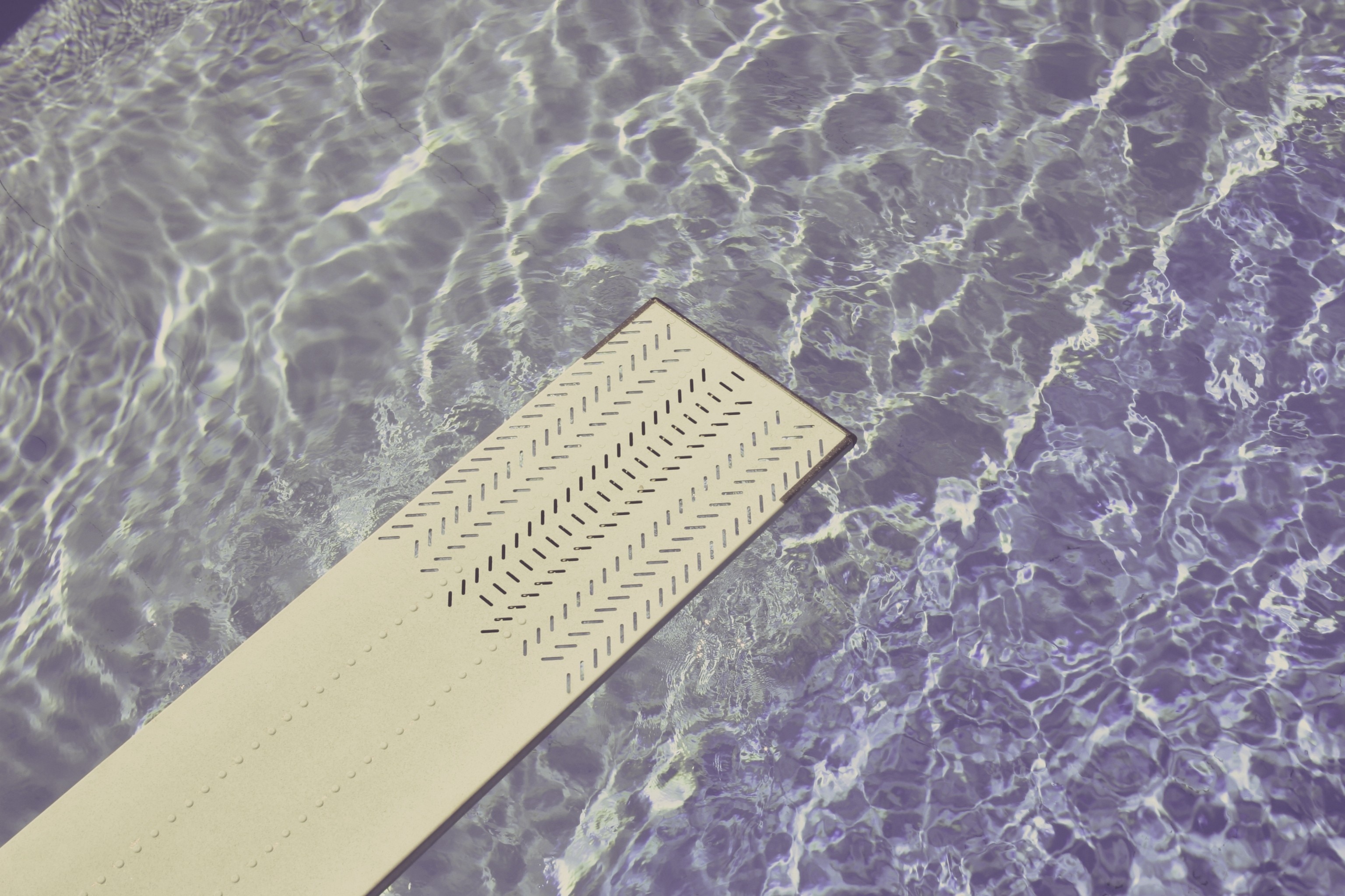 white diving board above water closeup photo