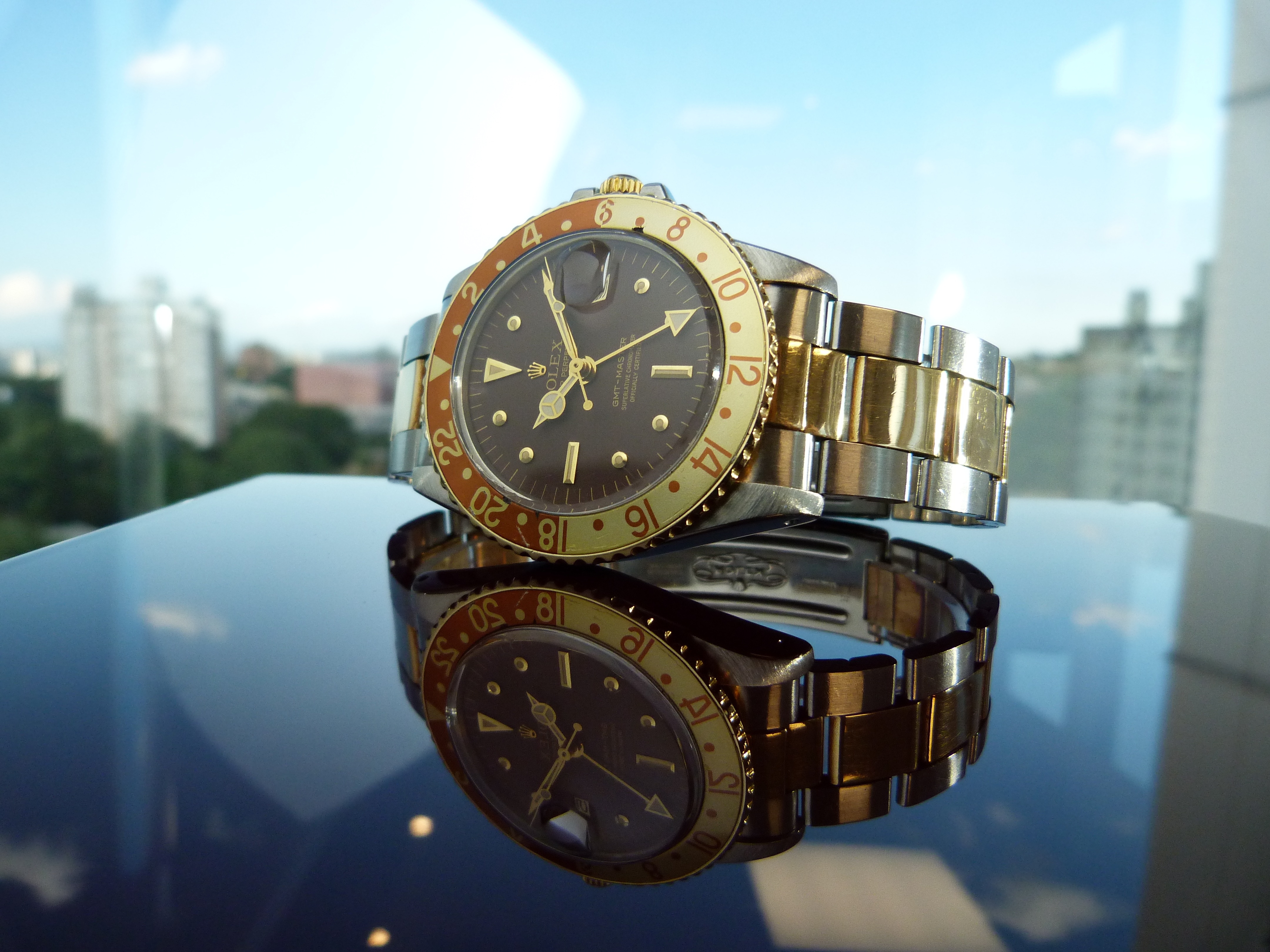 two tone gold and link black analog watch