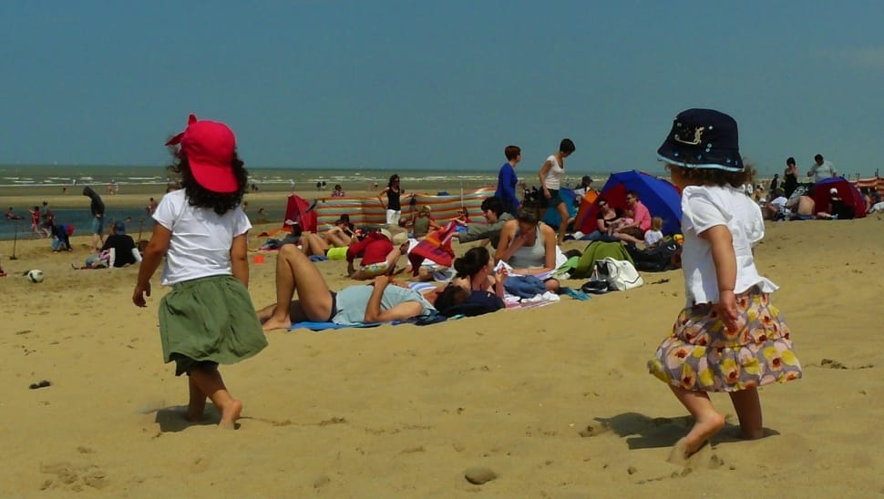 two toddler waling on brown sand at daytime preview