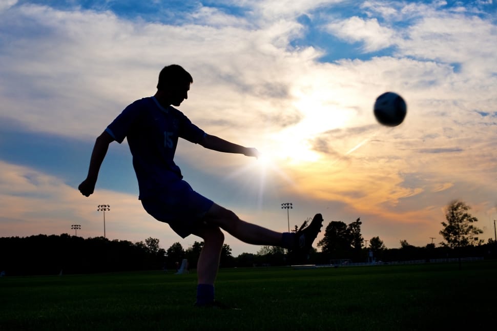 silhouette of soccer player and ball preview