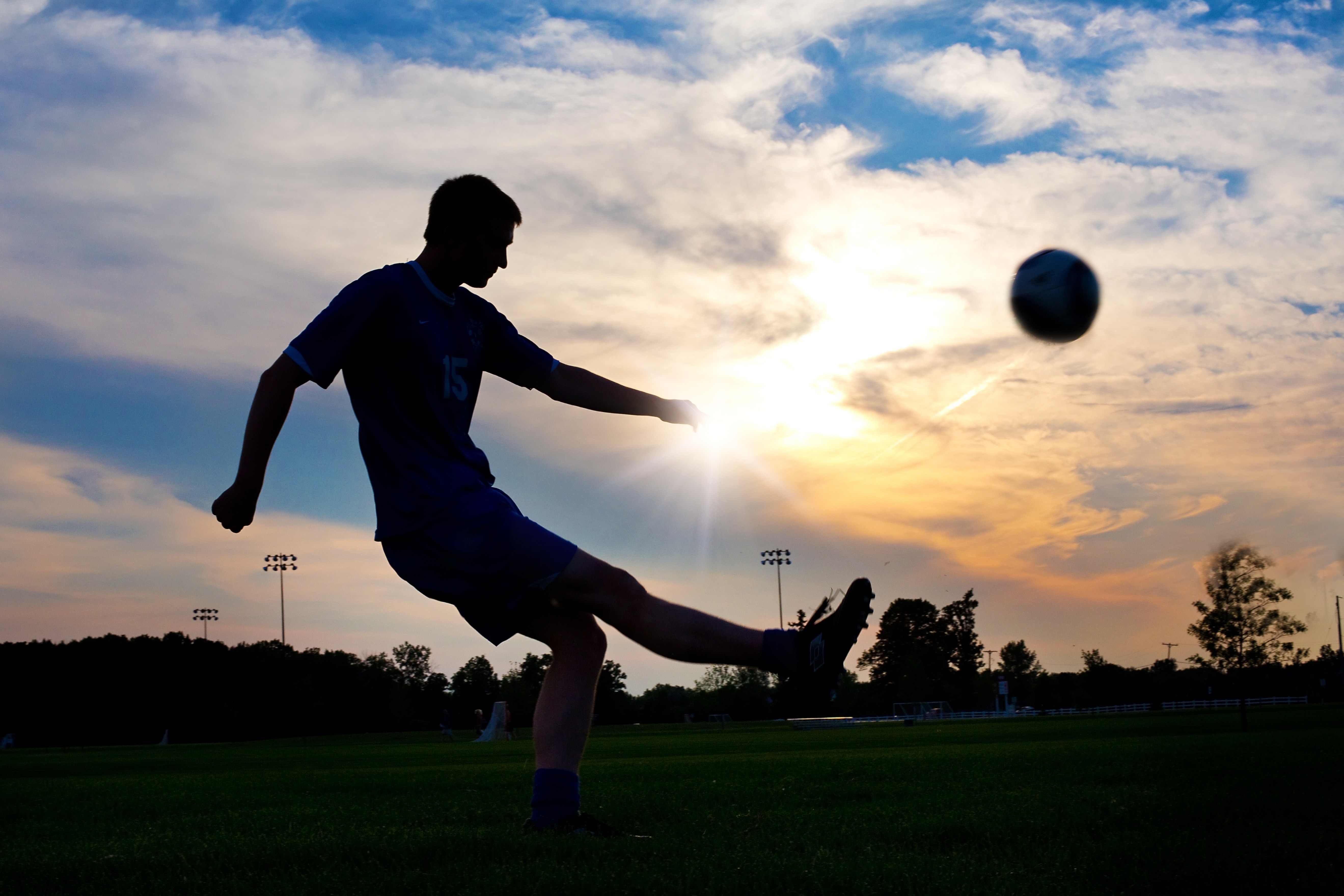 silhouette of soccer player and ball
