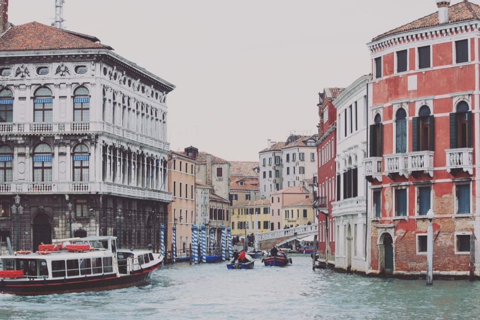 apartments in between river under white sky preview
