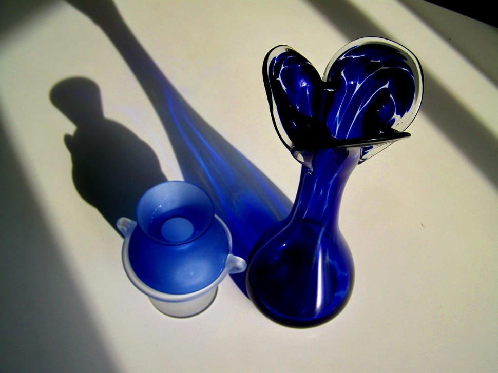 blue glass decanter on white surface preview