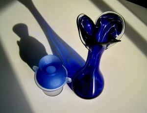 blue glass decanter on white surface thumbnail