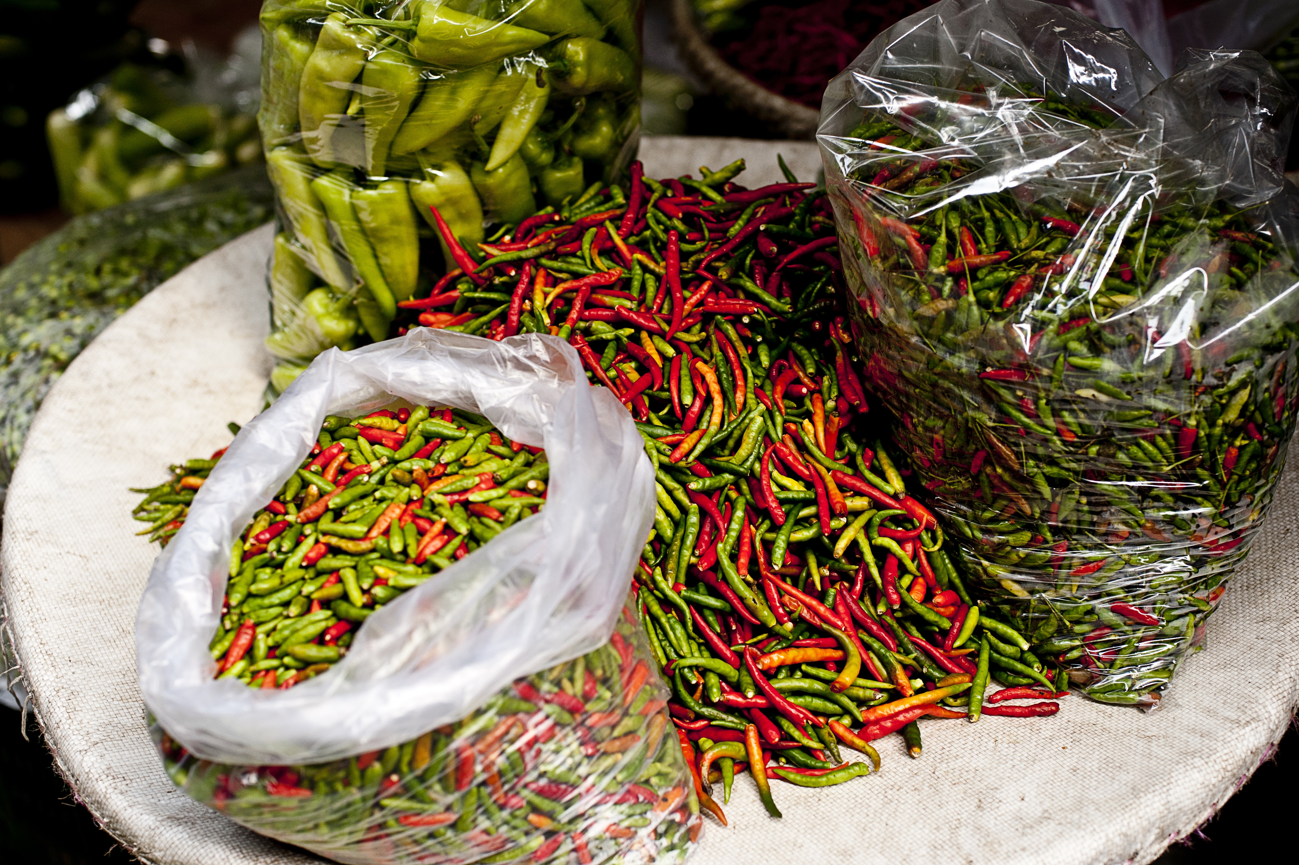 assorted green and red chilis on plate