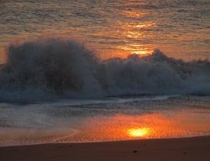 wave on the seashore during sunset thumbnail