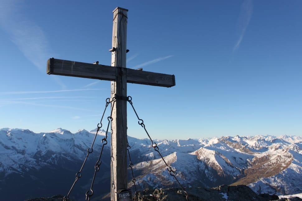 gray wooden cross near glacier mountains at daytime preview