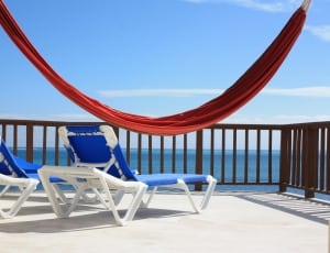 red hammock and two blue loungers thumbnail