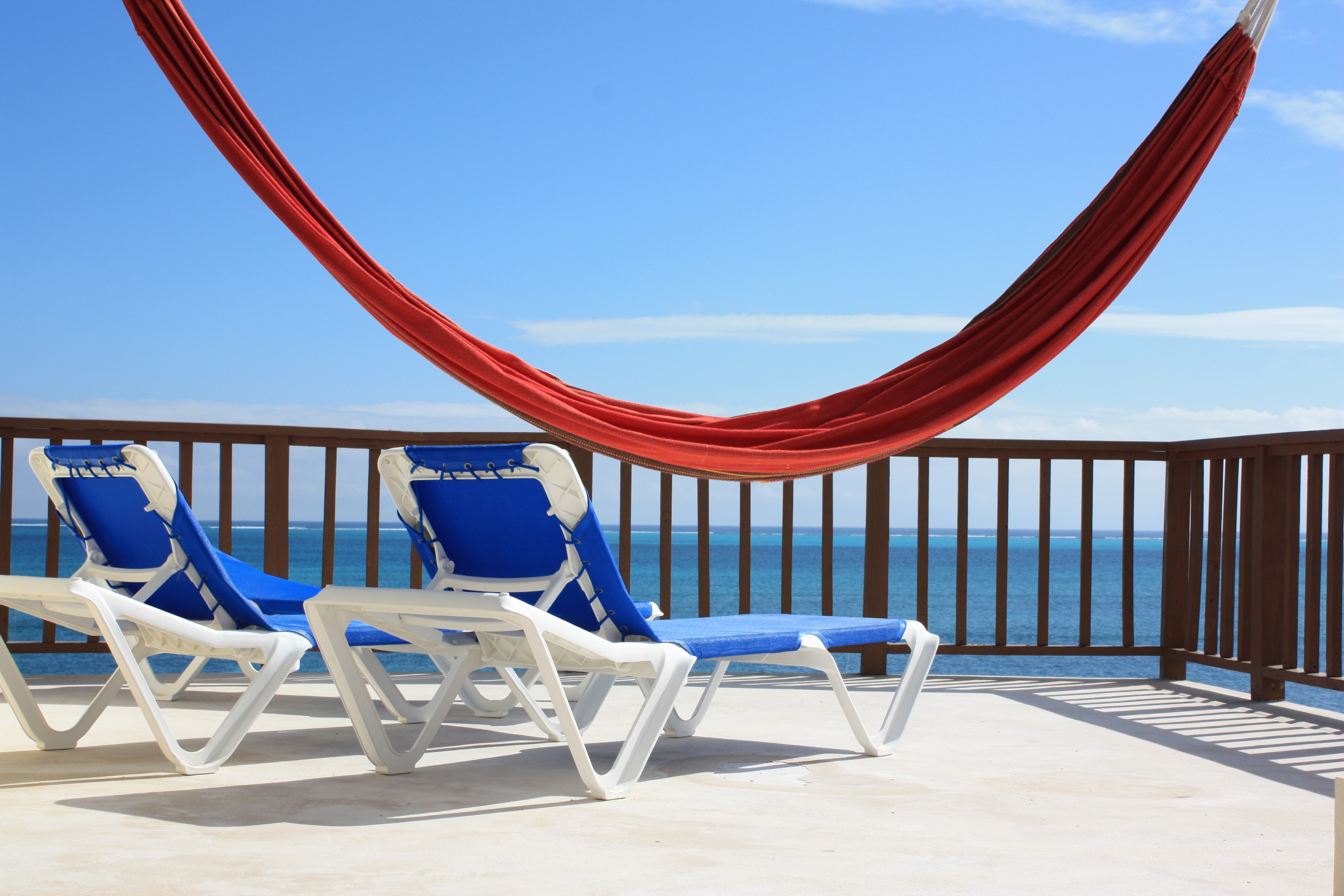 red hammock and two blue loungers