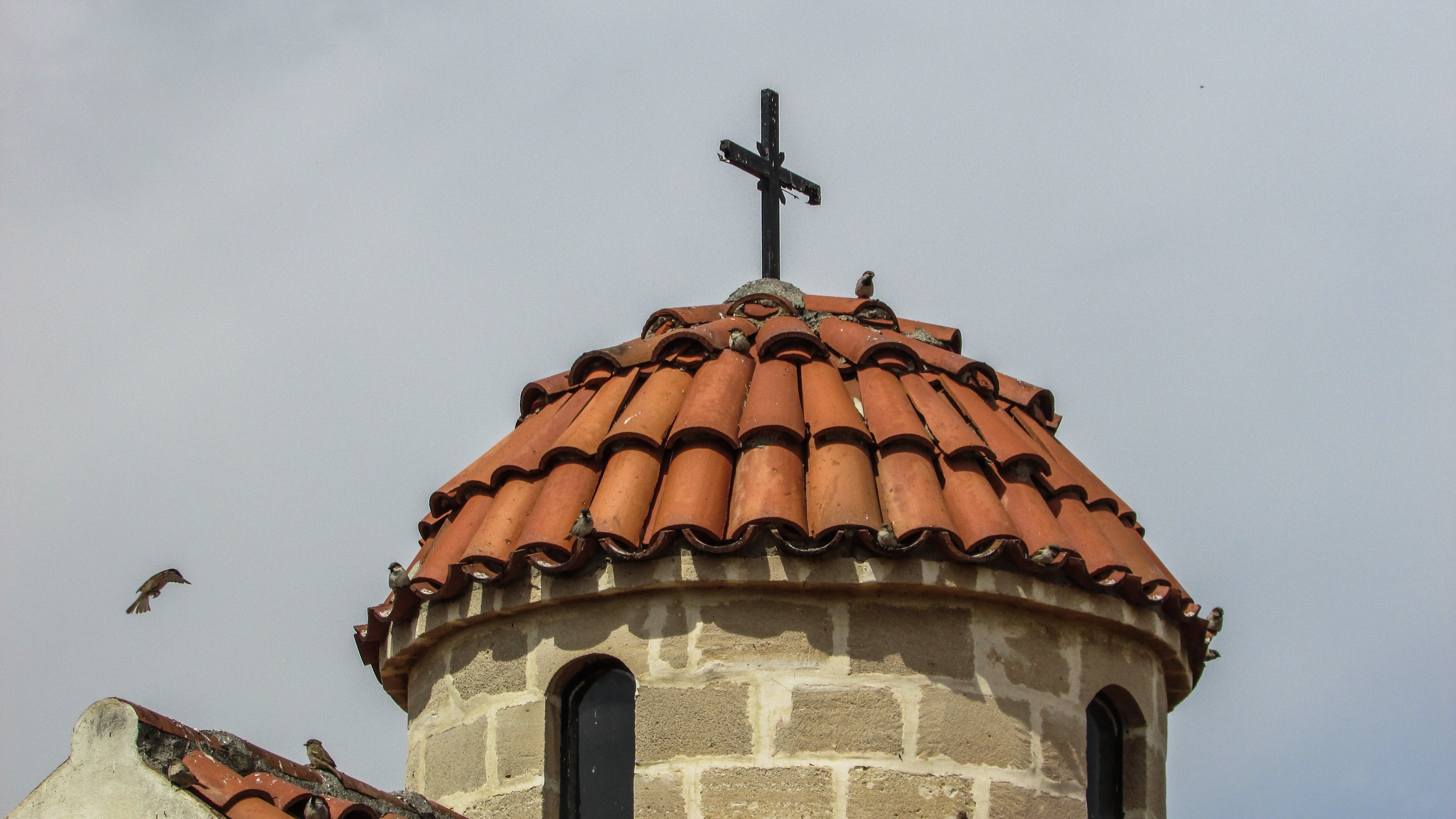 black cross on brown tower roof