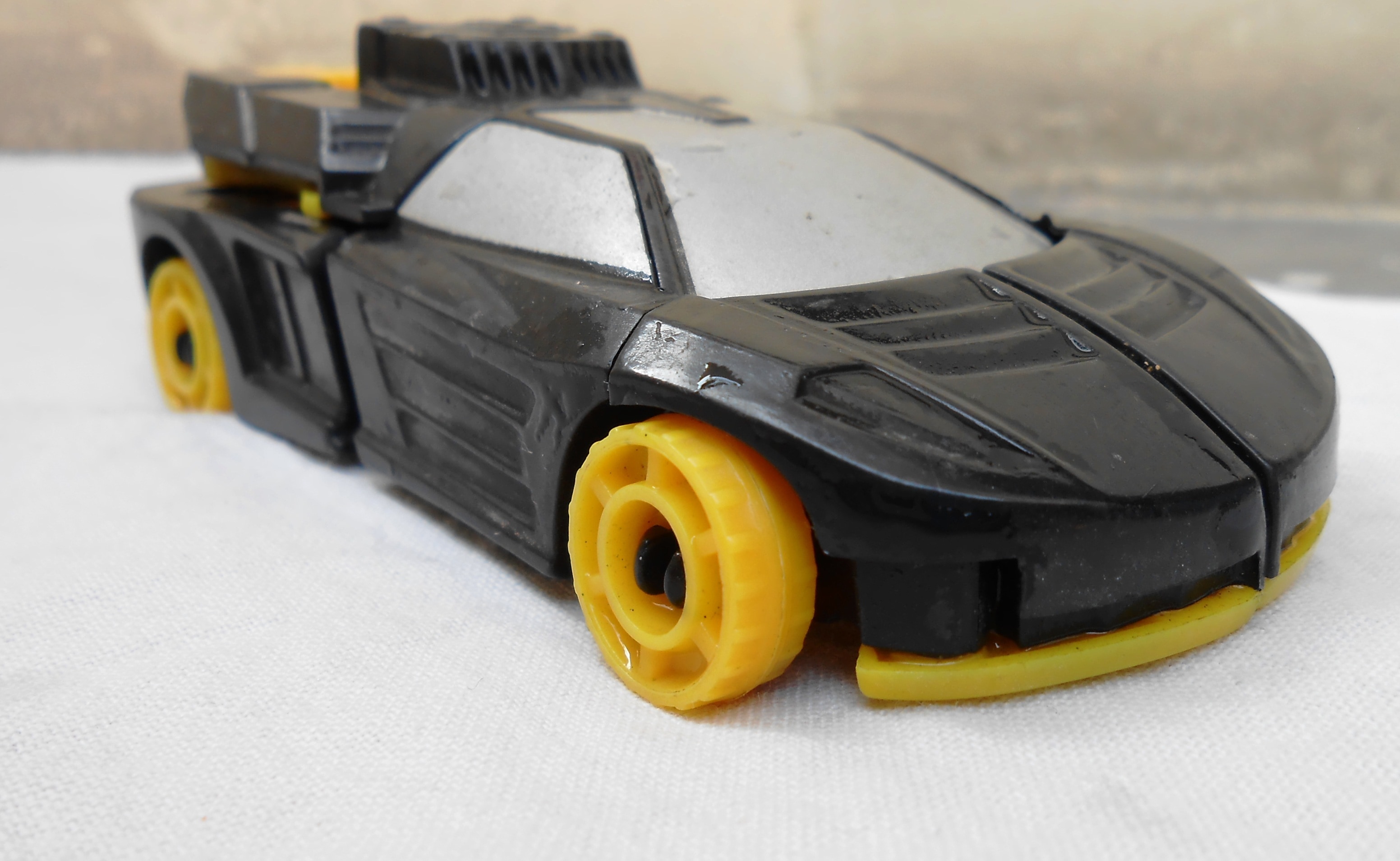 black and yellow plastic toy car