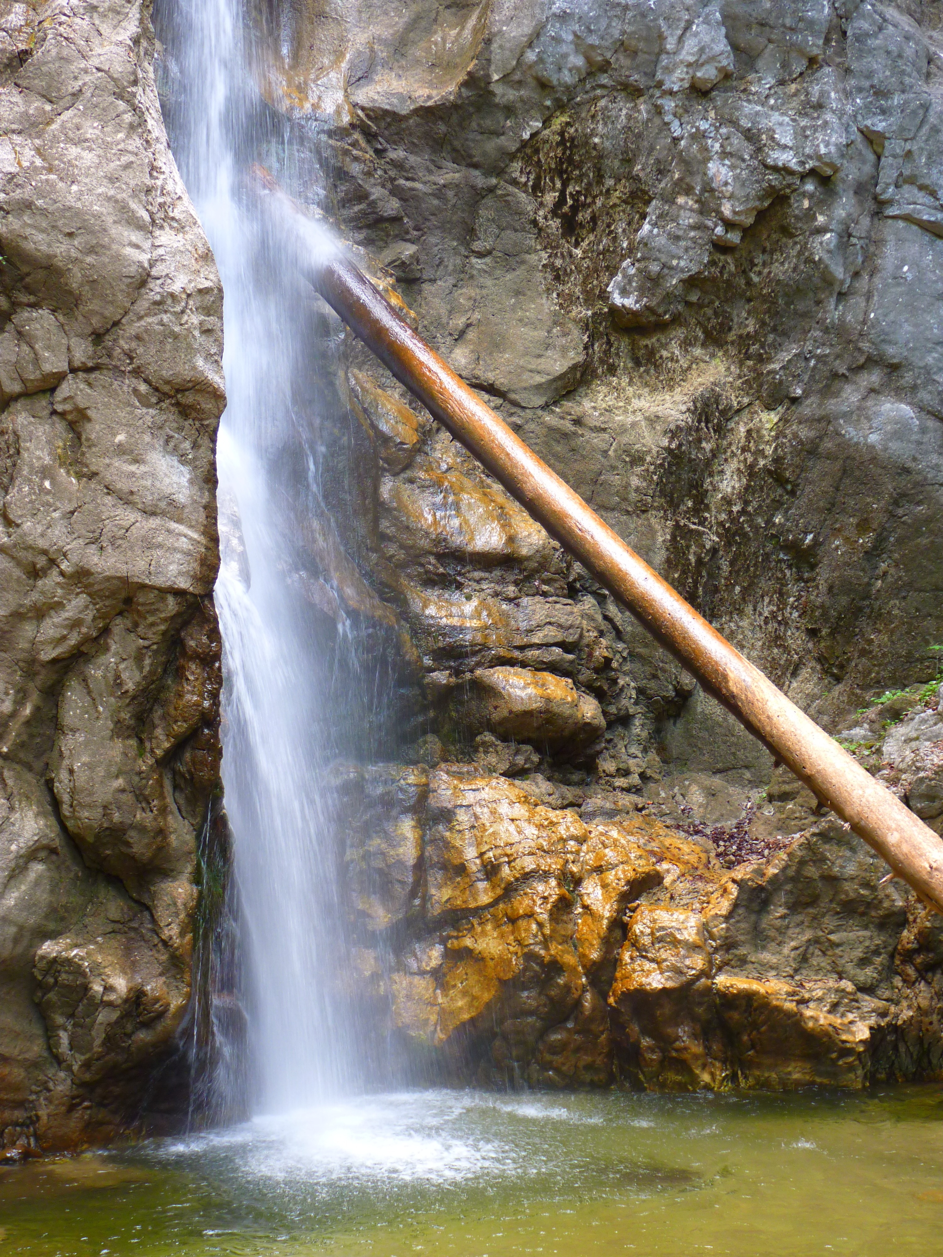wooden post on waterfalls