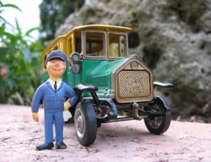 teal and yellow classic car scale model and policeman figure thumbnail