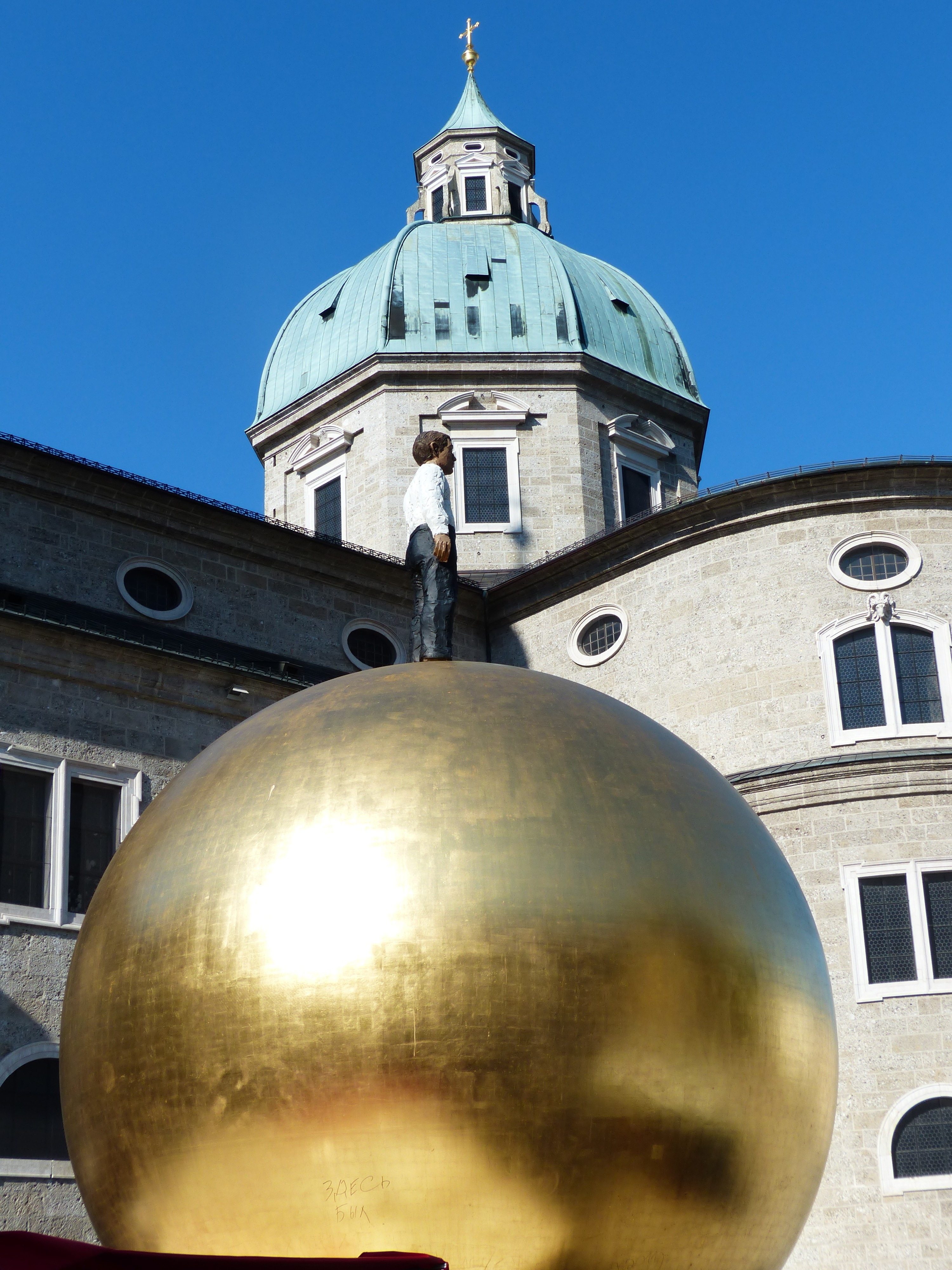 brass ball with human statue landmark