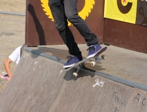 brown skateboard and purple and black skateboard shoes thumbnail