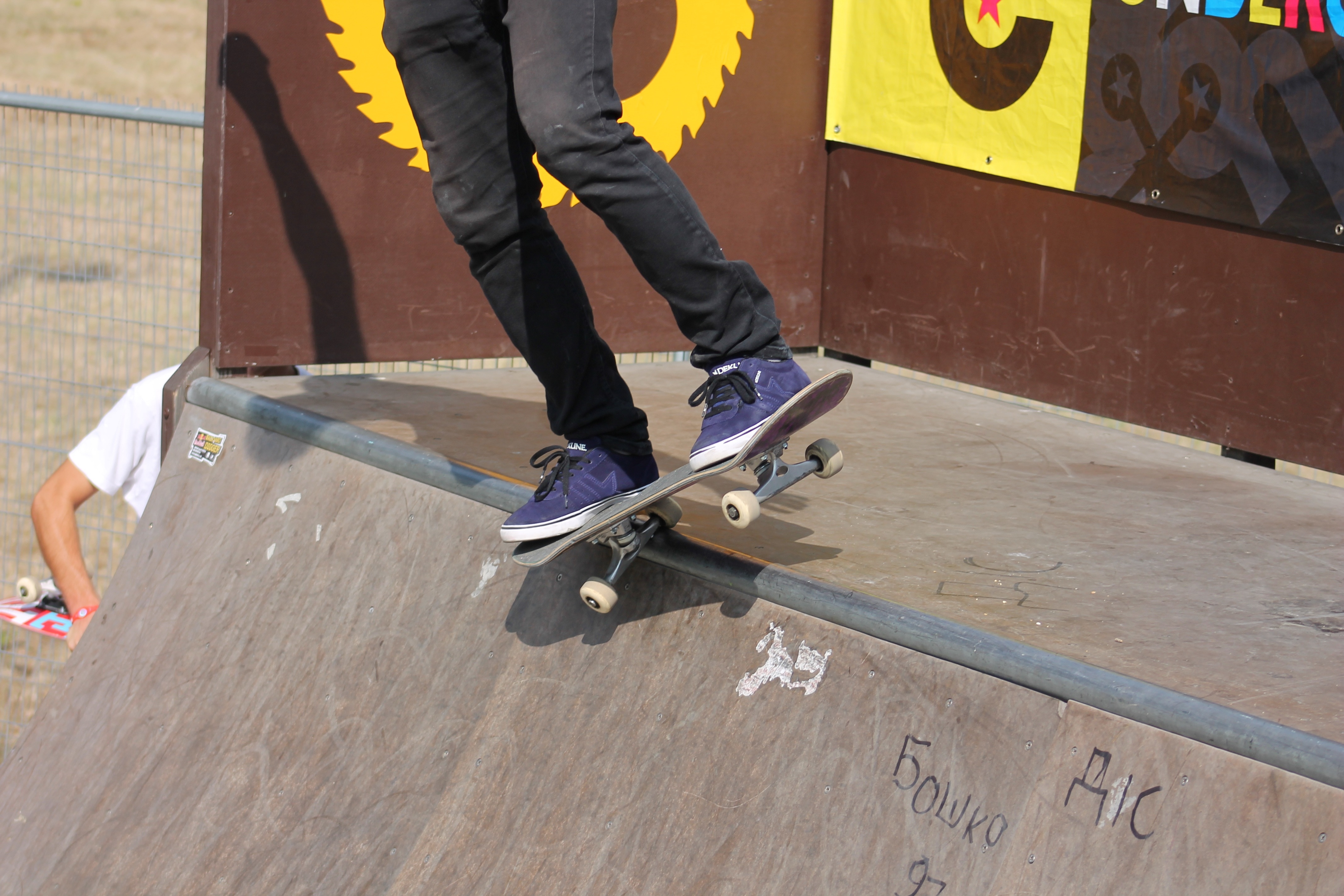 brown skateboard and purple and black skateboard shoes