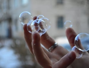 bubbles near human fingers thumbnail