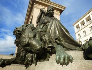 grey lion and man statue thumbnail
