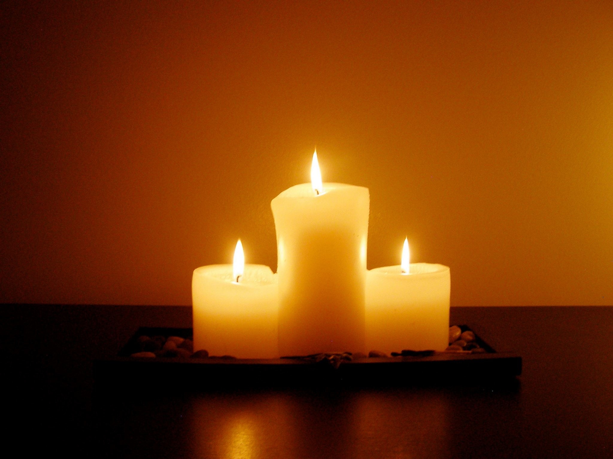 3 pillar lighted candles