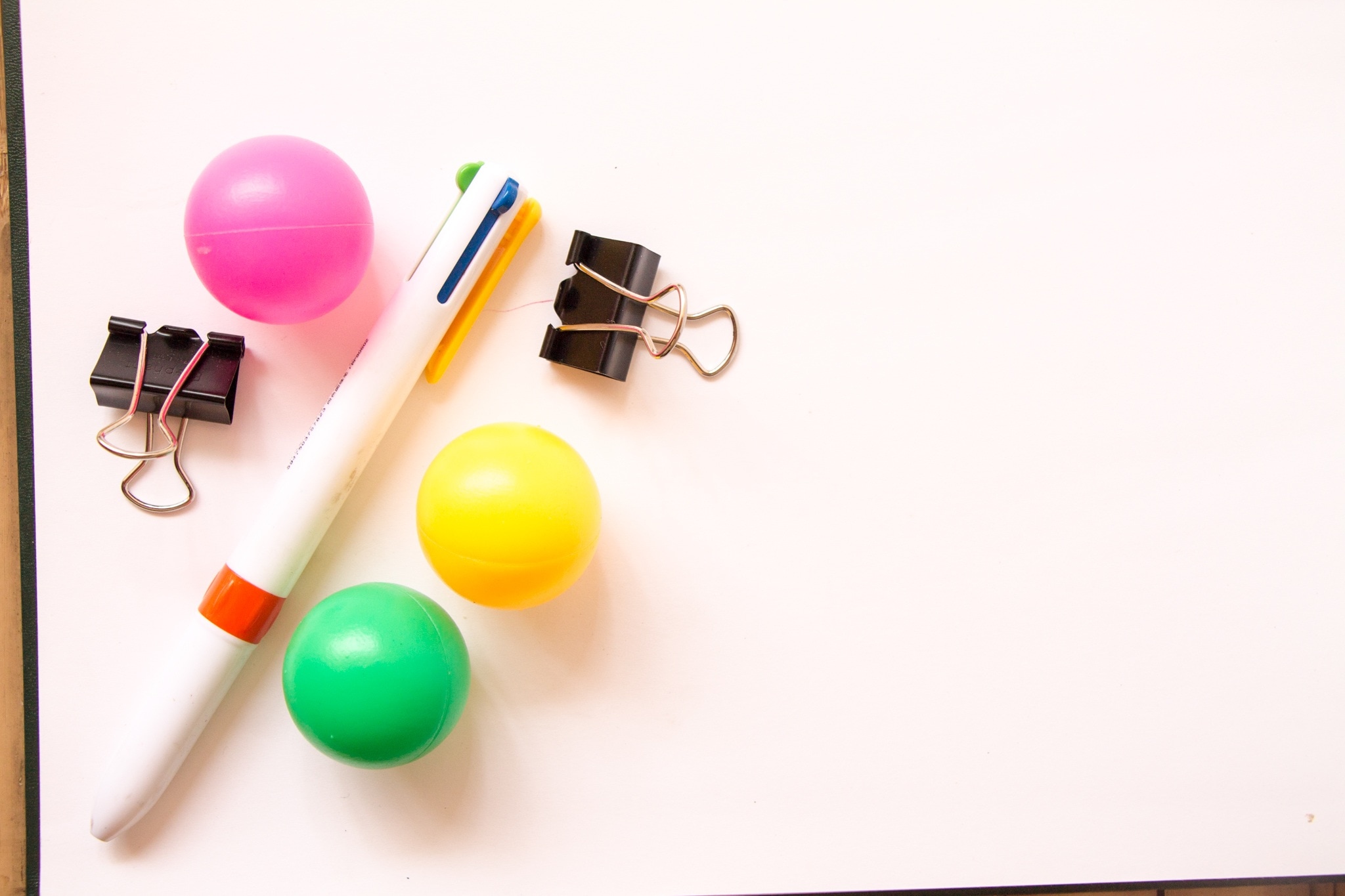 multi-colored pen and 3 plastic balls