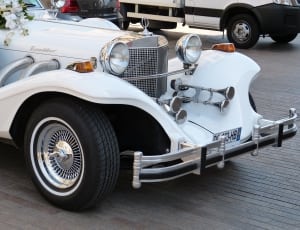 white vintage luxury roadster thumbnail