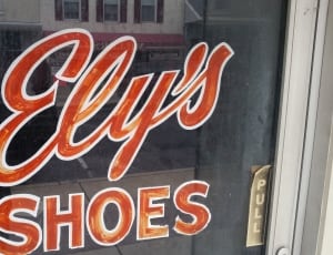white wooden framed ely's shoes signage thumbnail