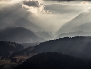 silhouette of mountain under gray clouds during daytime thumbnail
