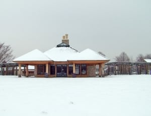 brown wooden house covered with snow thumbnail