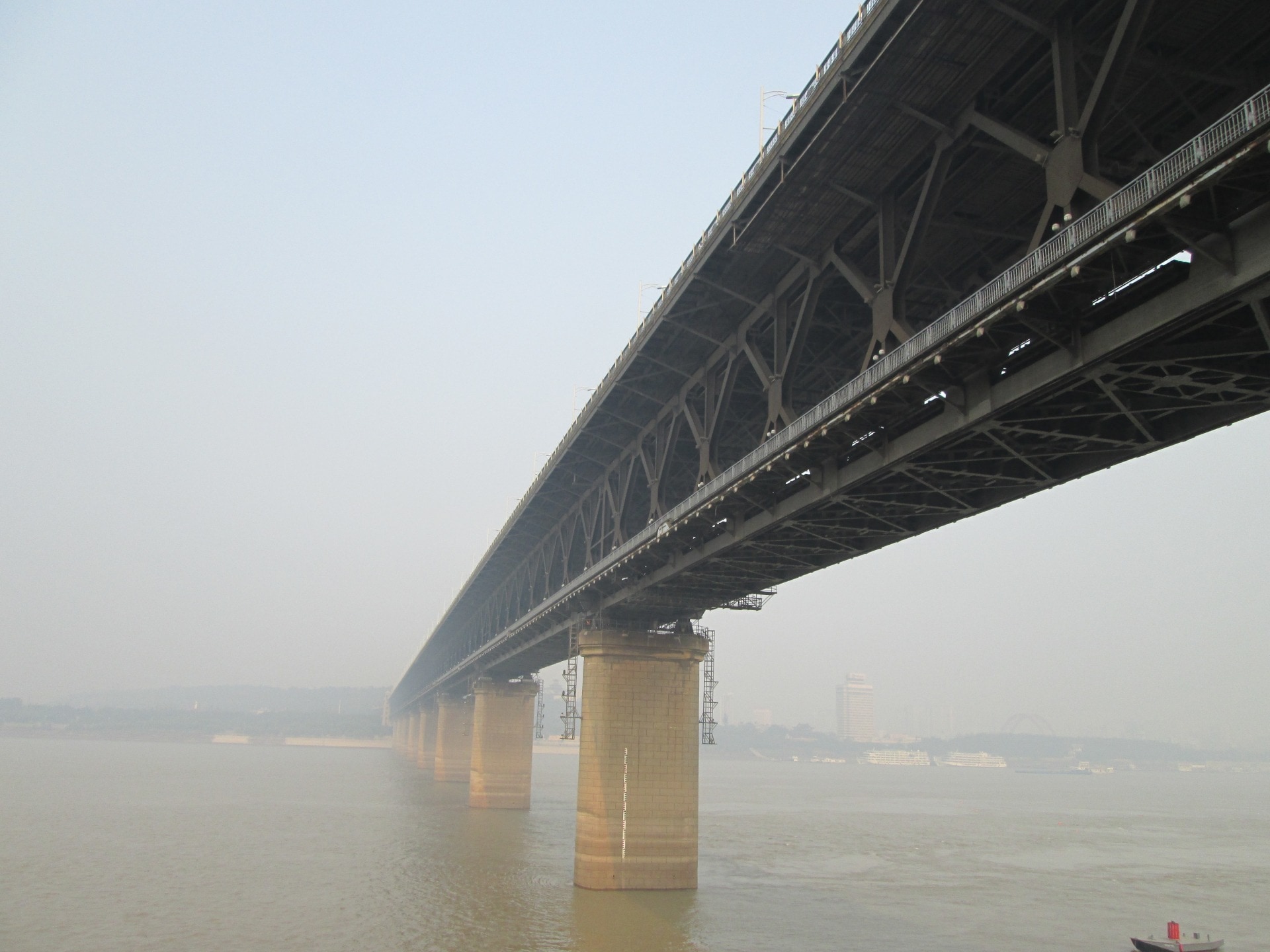 low angle photo of grey metal bridge during daytime