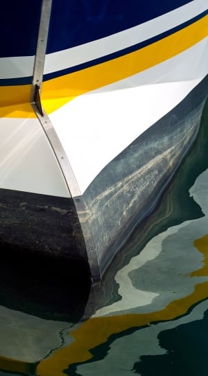 yellow white and blue boat thumbnail