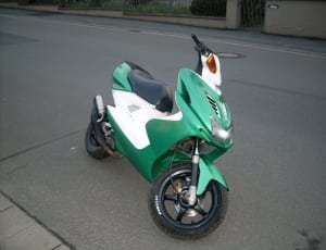 green and white motor scooter thumbnail