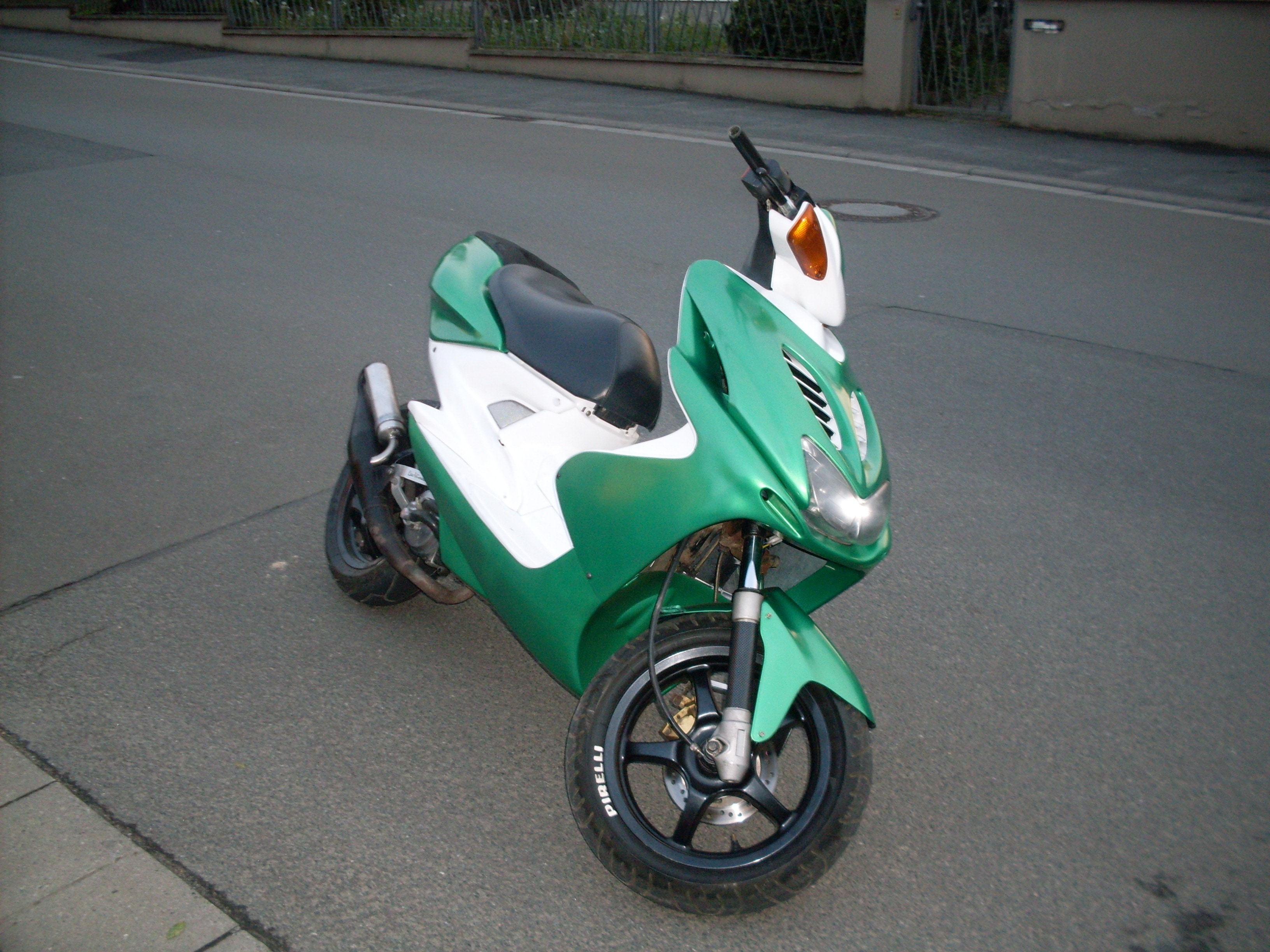 green and white motor scooter