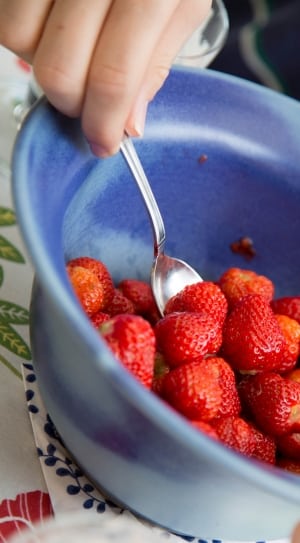 red strawberries and blue ceramic bowl thumbnail