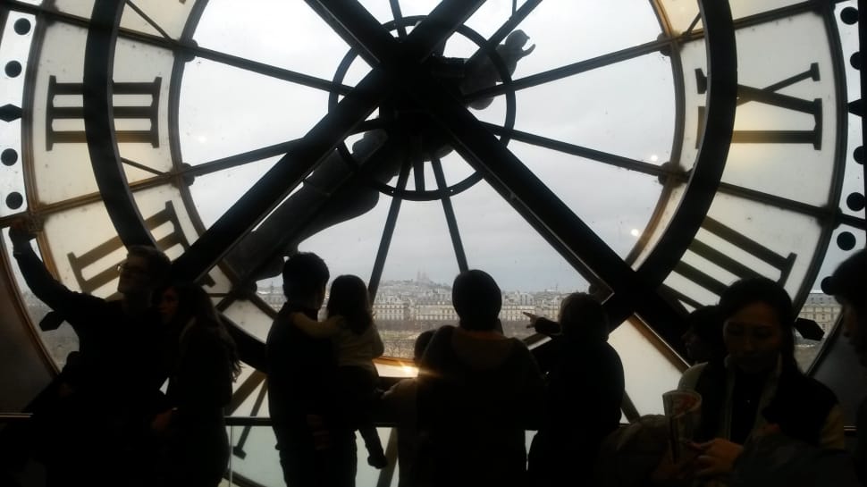 silhouette of people inside clock tower during day preview