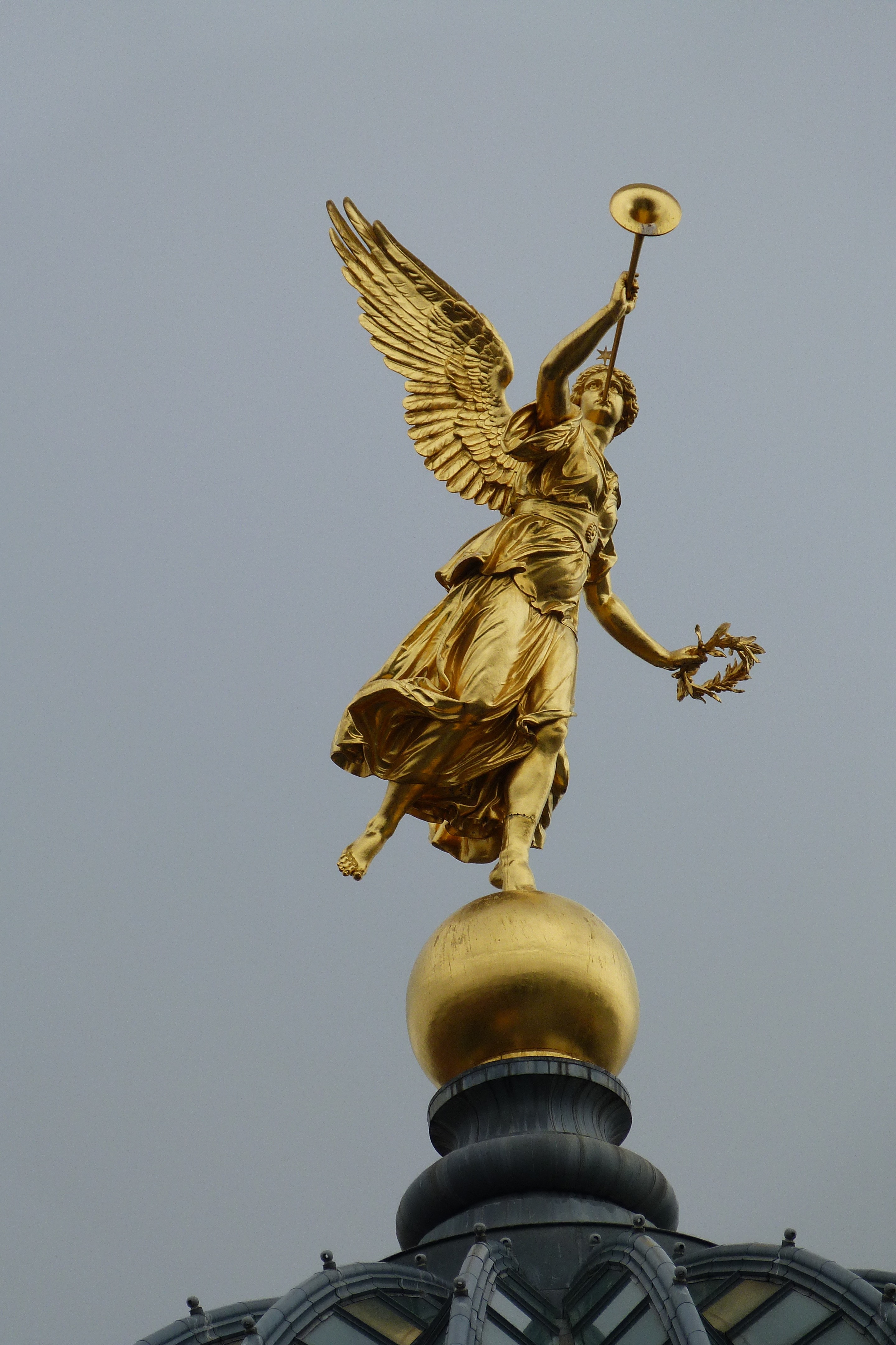 low angle photo of a gold Angel Statue