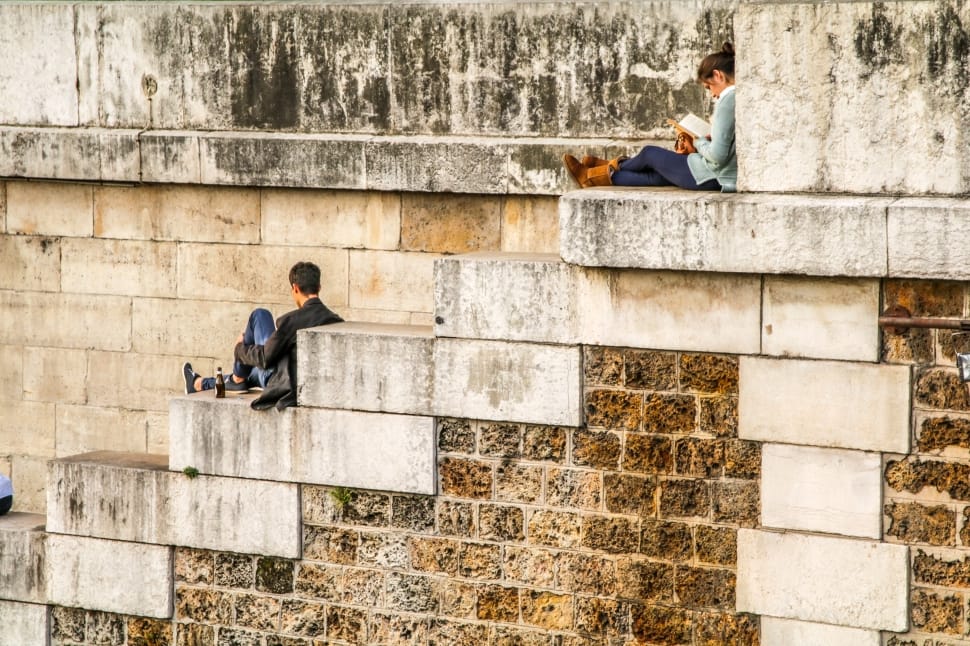 woman and man sitting on concrete stairs preview